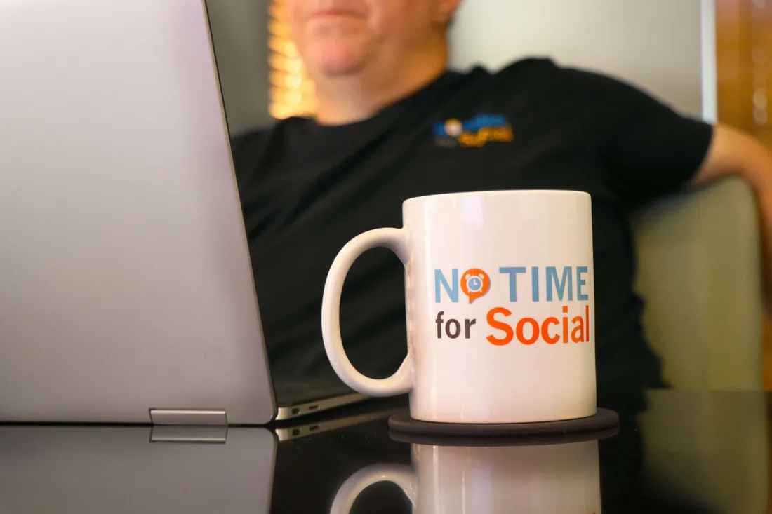 Bill in the office with a No Time for Social mug
