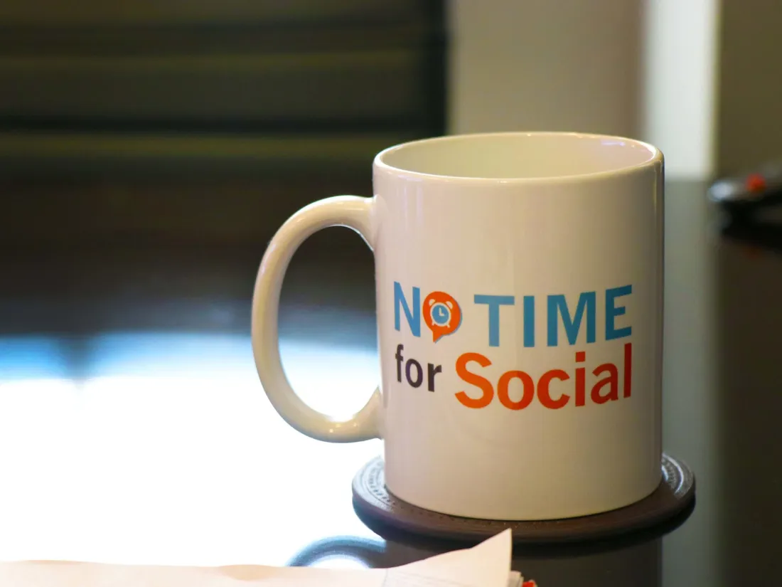 A No Time for Social mug on a desk in the Round Rock office